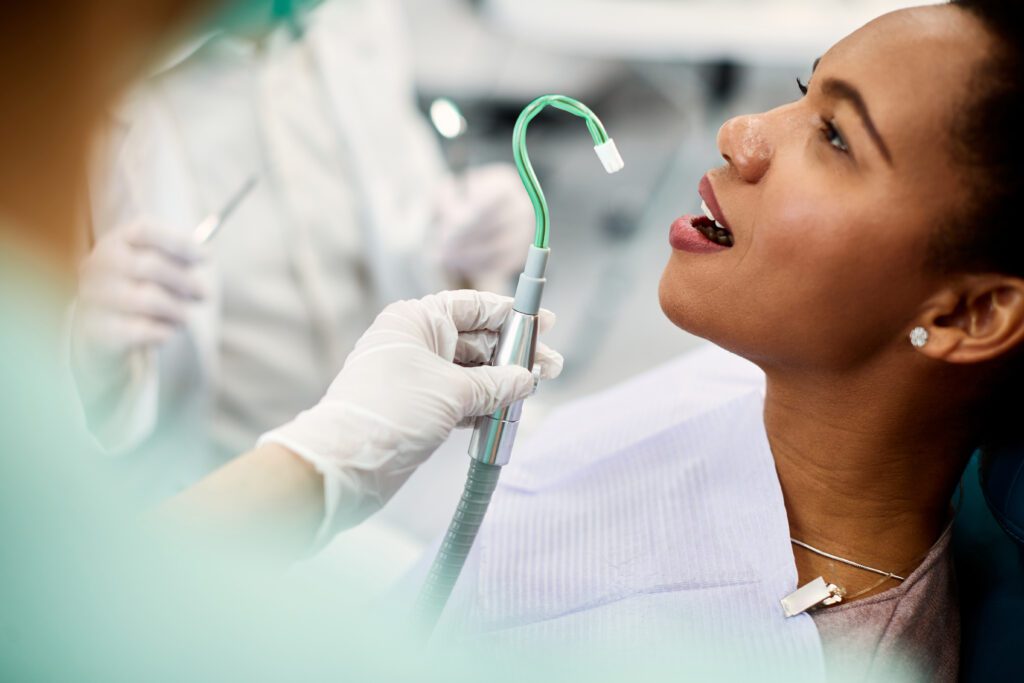 African American woman having dental check-up at dentist's office.